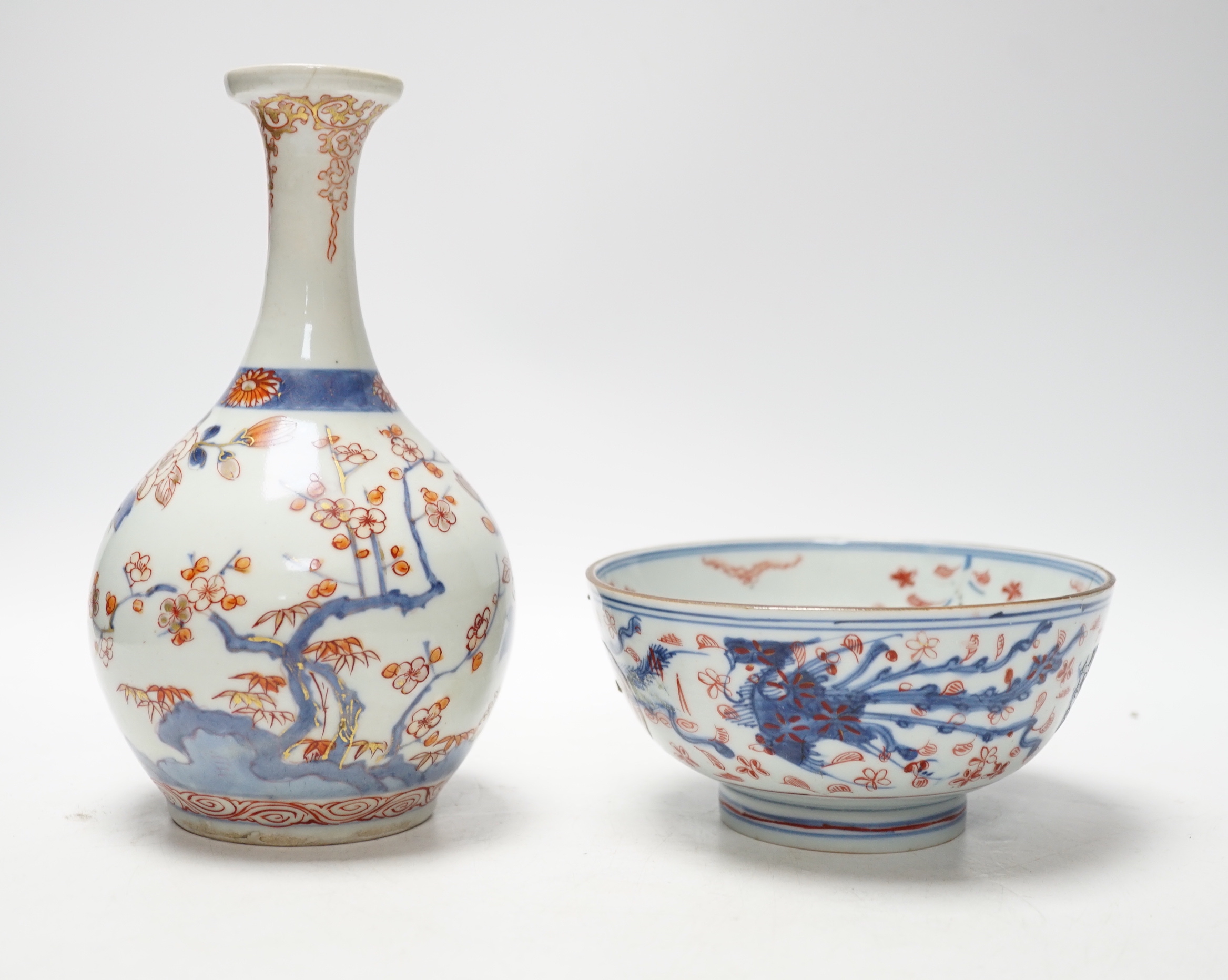 An 18th century Japanese Imari sake flask and a Chinese clobbered blue and white bowl (a.f), tallest 20cm